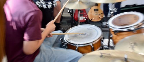 Efterskoleelev spiller trommer til musik på Sædding Efterskole